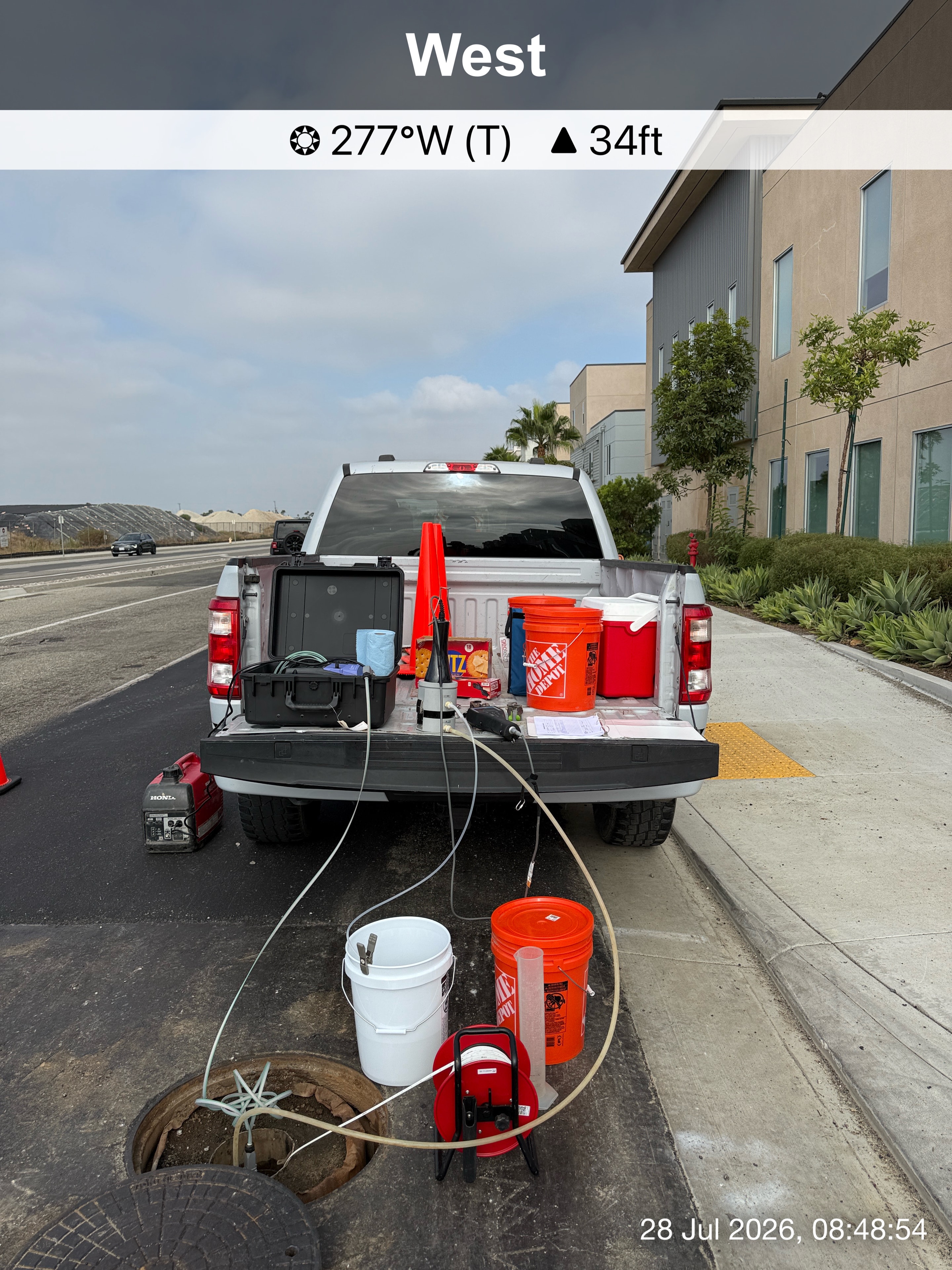 Field monitoring equipment staged beside a roadside work truck